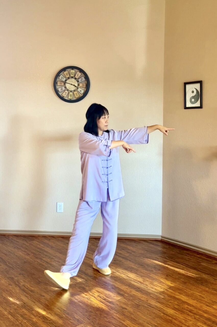 Vicki Zhao practicing a Tai Chi form indoors
